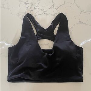 Lululemon S/M Never worn. Sports bra. Black. Boob pads included.
